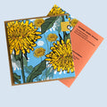 A square print  featuring a stylized floral illustration with large yellow flowers, green leaves, and a light blue background. Irish Folklore Greeting Card, made in west cork. Sustainable Packaging.